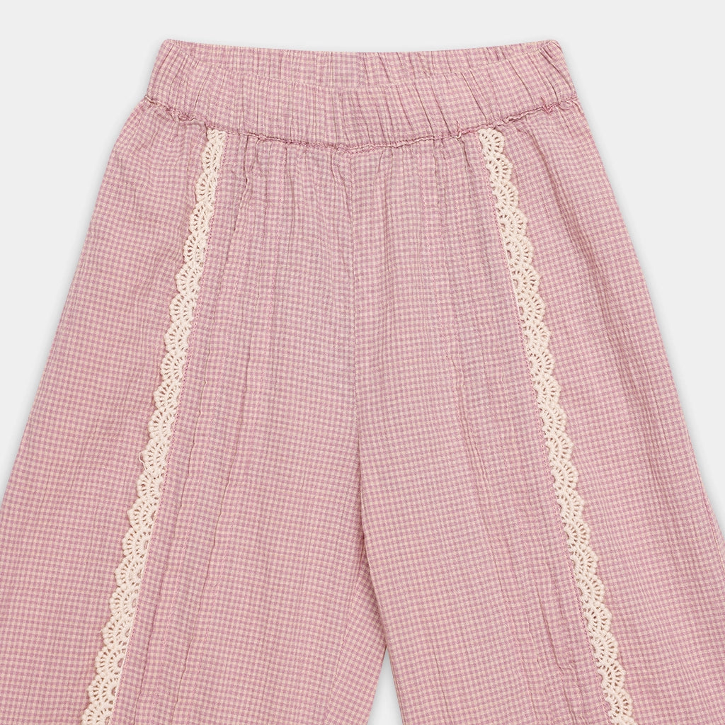 Pink checkered pants with lace trim on a white background