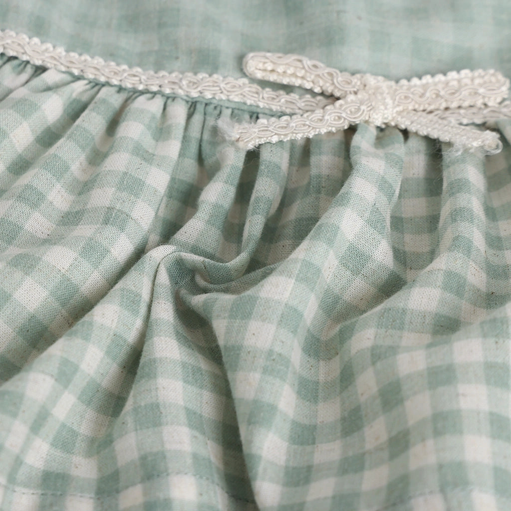 Green and white checkered fabric with decorative trim