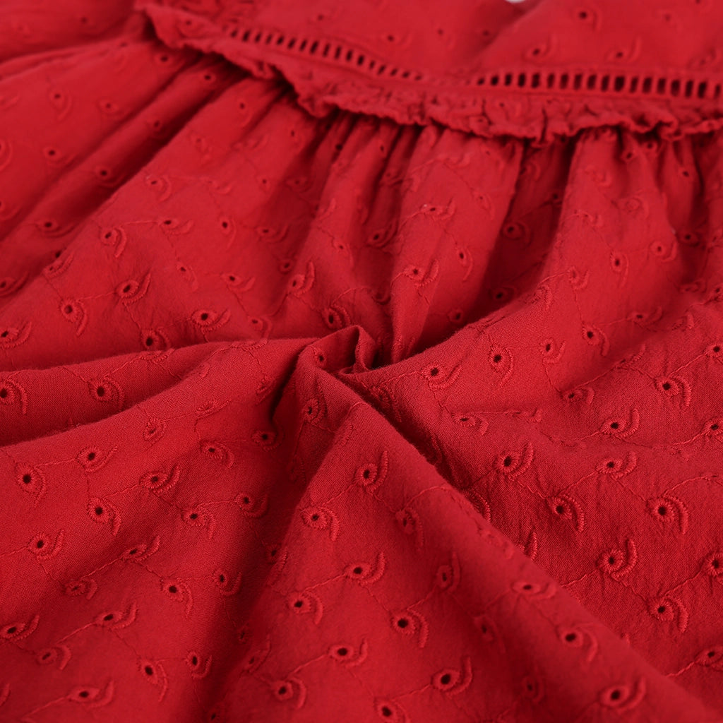 Close-up of a red fabric with a textured pattern