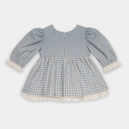 Gray checkered dress with ruffled trim on a white background