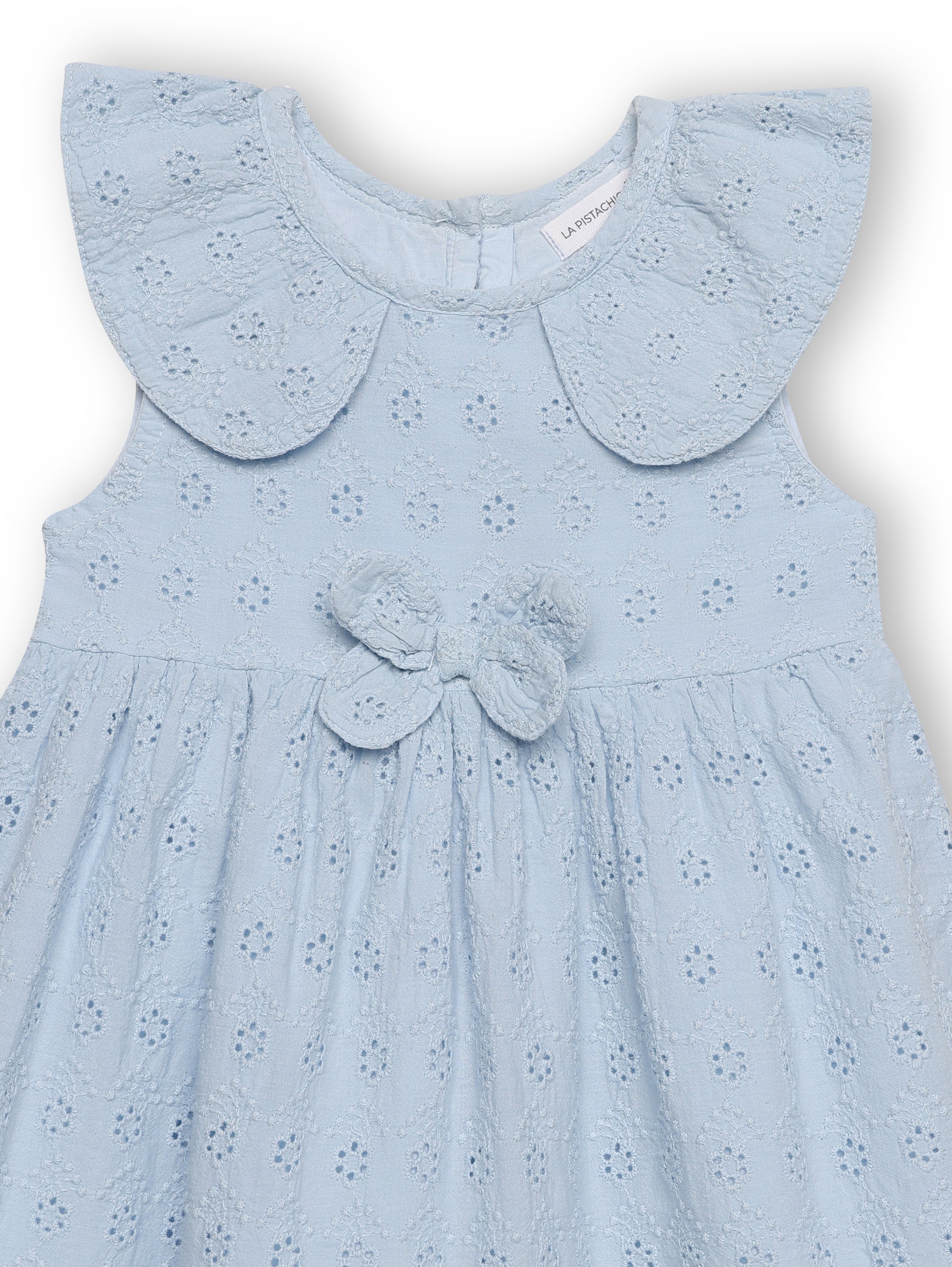 Light blue dress with a butterfly detail on a white background