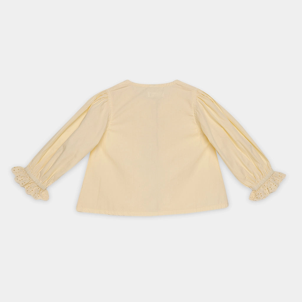 Yellow blouse with sheer sleeves on a white background