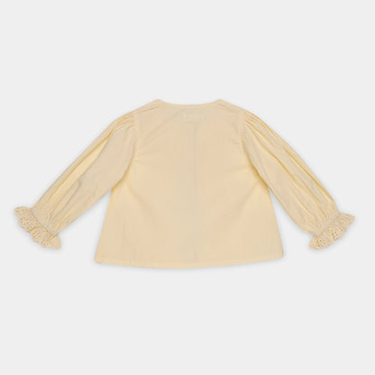 Yellow blouse with sheer sleeves on a white background
