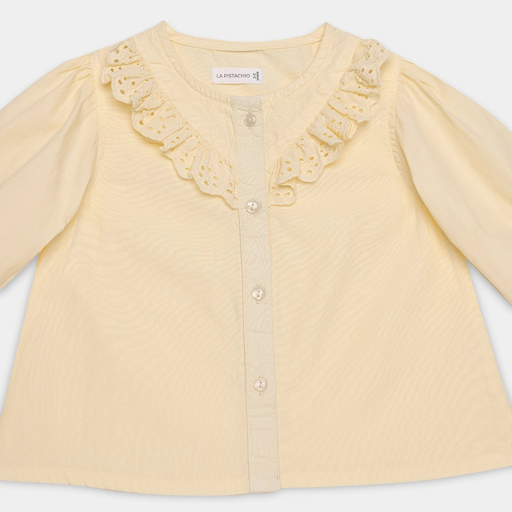 Yellow cardigan with lace details on a white background
