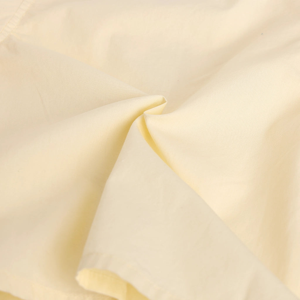 Close-up of beige fabric with a subtle texture