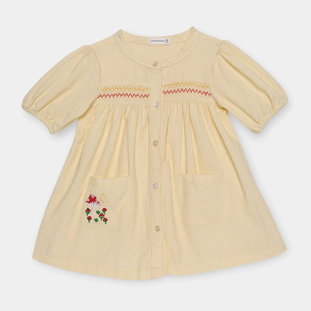 Beige dress with floral embroidery on a white background
