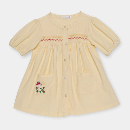 Beige dress with floral embroidery on a white background
