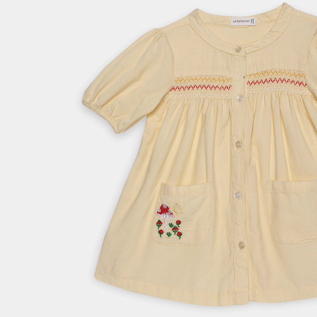 Beige dress with floral embroidery on a white background