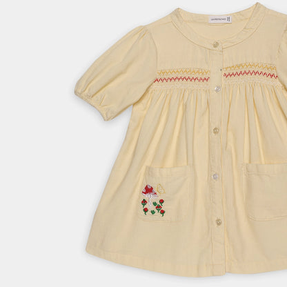 Beige dress with floral embroidery on a white background