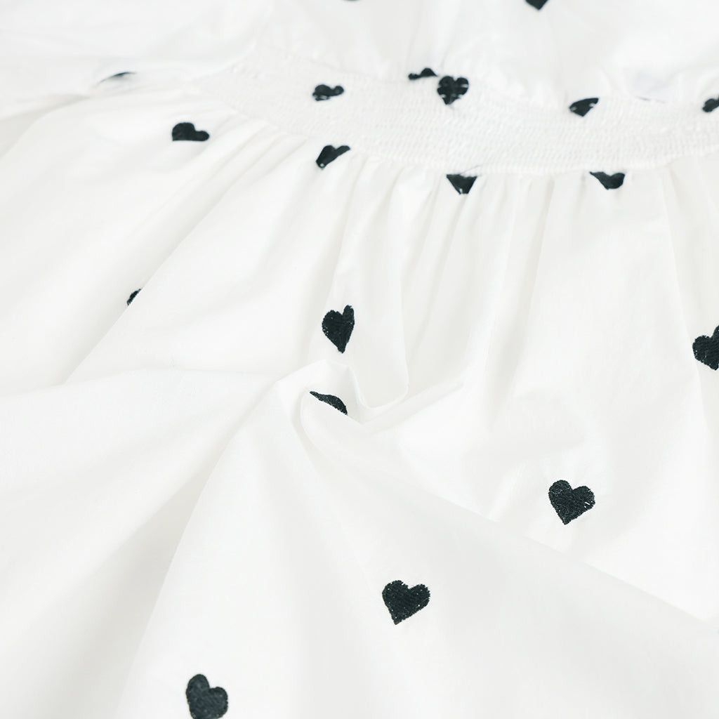White fabric with black heart patterns