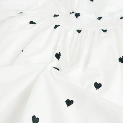 White fabric with black heart patterns