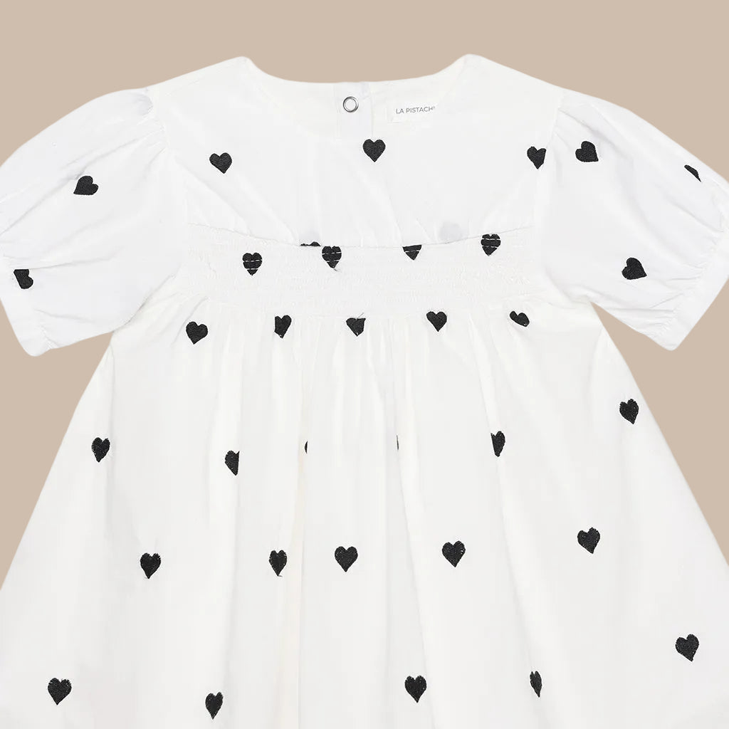 White shirt with black heart patterns on a white background