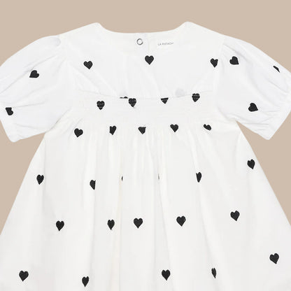 White shirt with black heart patterns on a white background