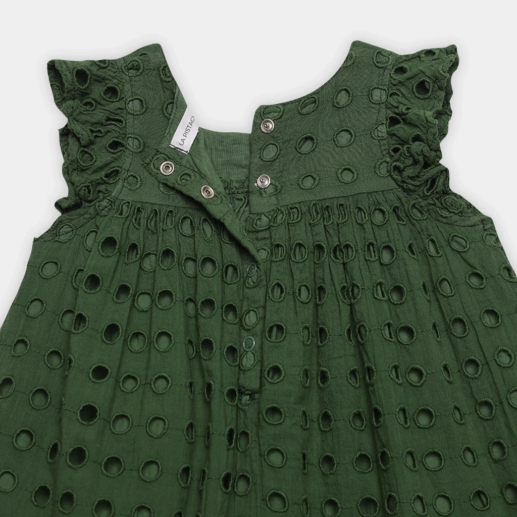 Green dress with cut-out pattern on a white background