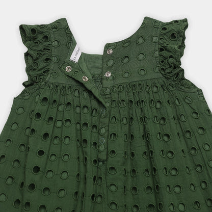 Green dress with cut-out pattern on a white background