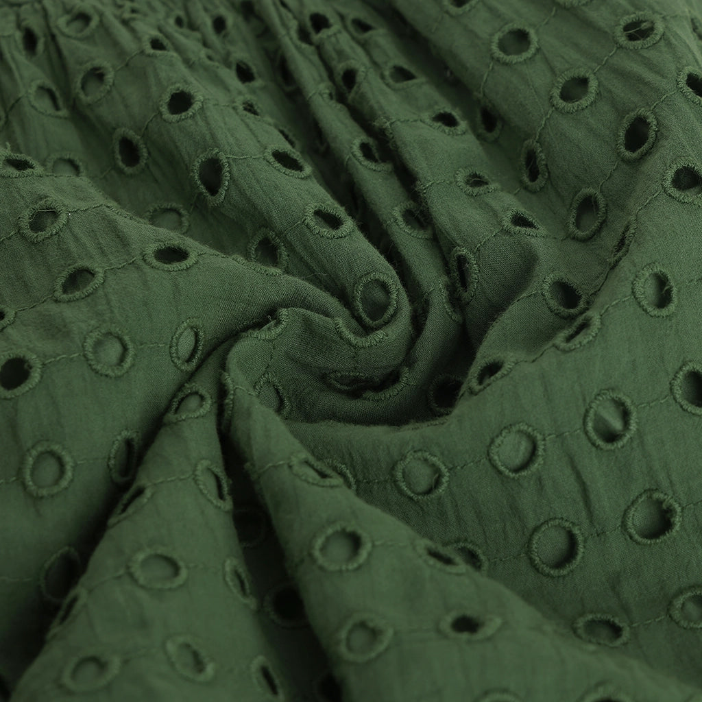 Close-up of green fabric with circular patterns