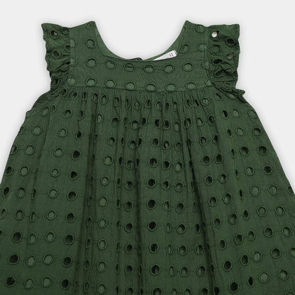 Green dress with circular cut-out pattern on a white background