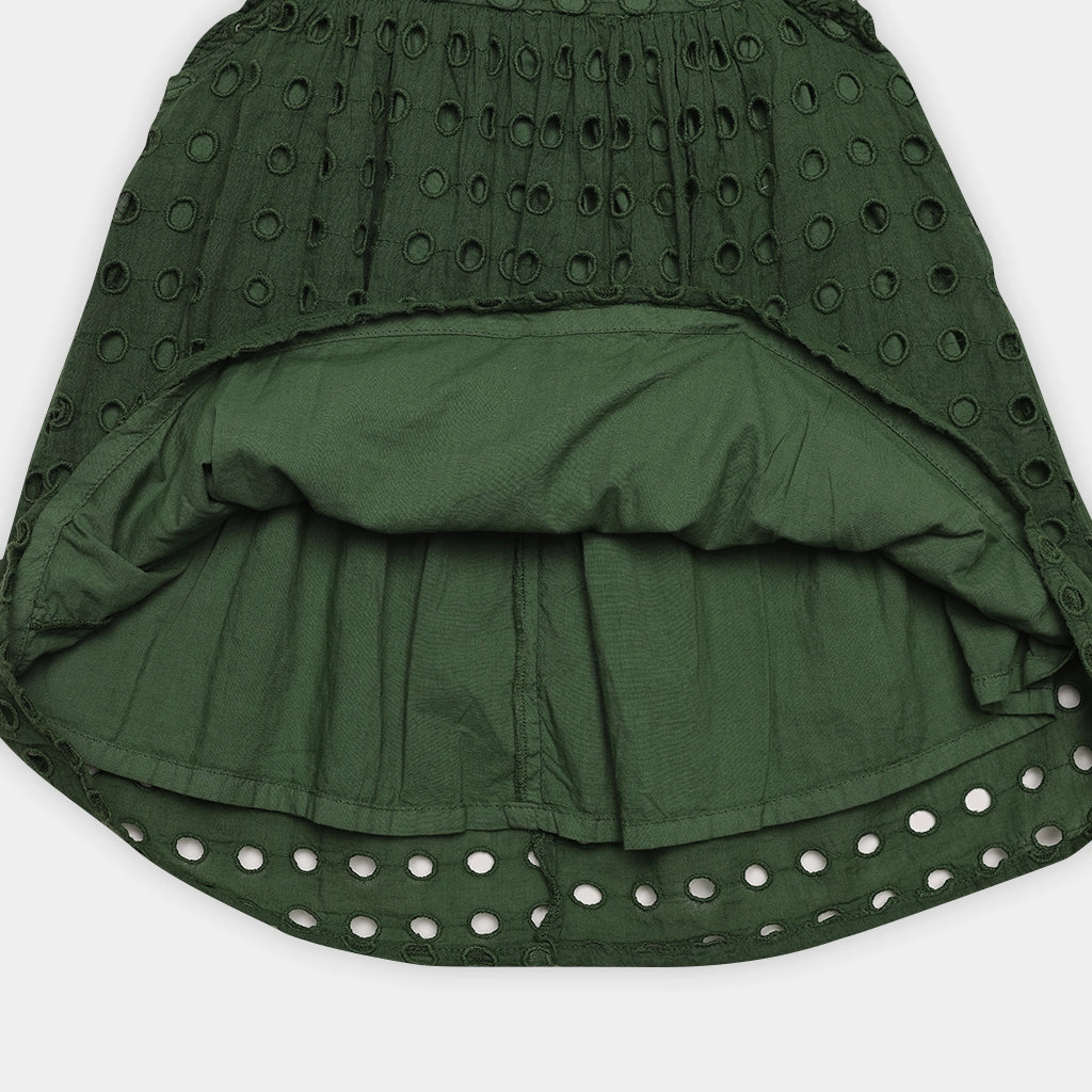 Green skirt with cut-out pattern on a white background