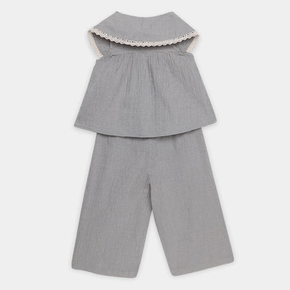 Gray checkered top and pants set on a white background