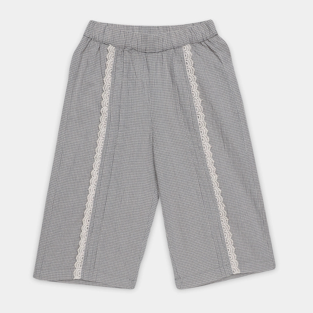 Gray checkered pants with lace trim on a light gray background