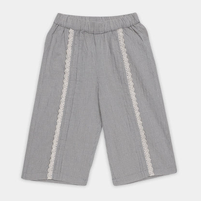 Gray checkered pants with lace trim on a light gray background