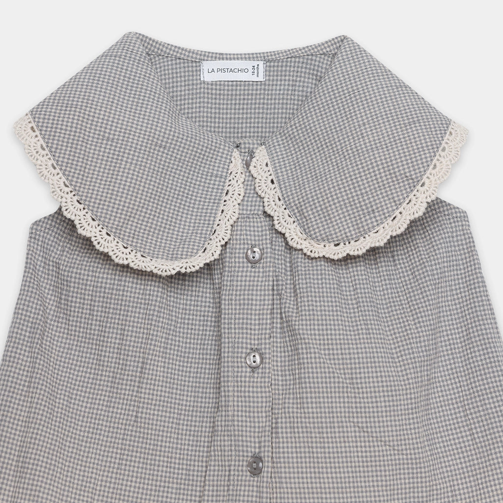 Gray checkered shirt with lace collar on a white background
