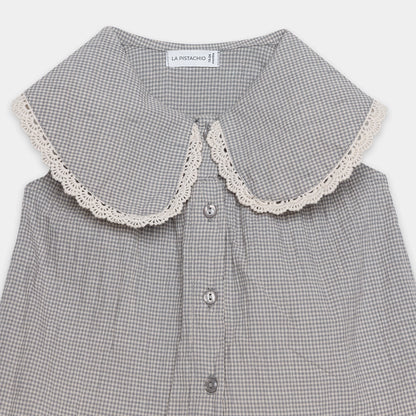 Gray checkered shirt with lace collar on a white background
