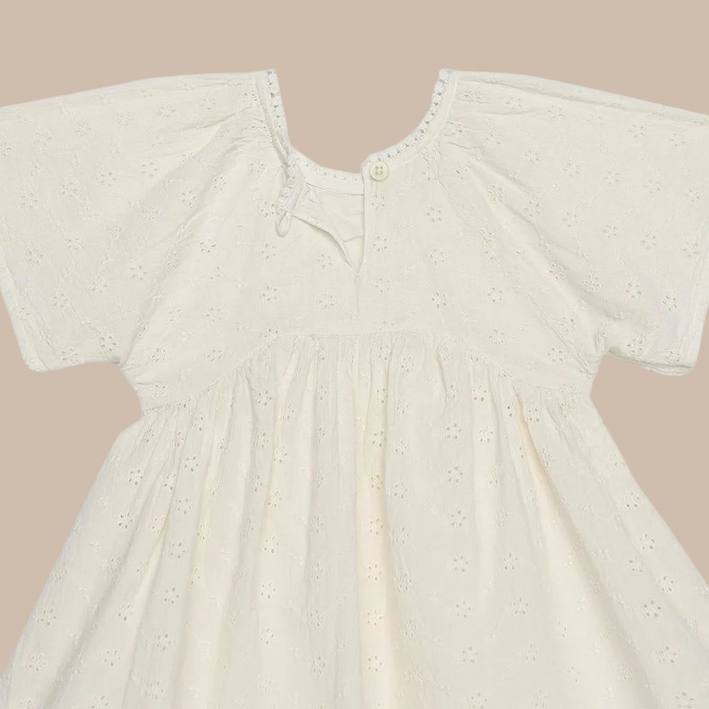 Beige baby dress with short sleeves on a white background