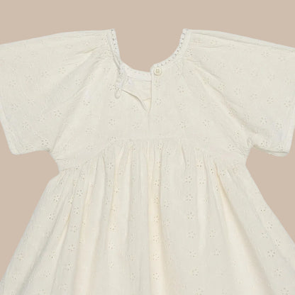 Beige baby dress with short sleeves on a white background