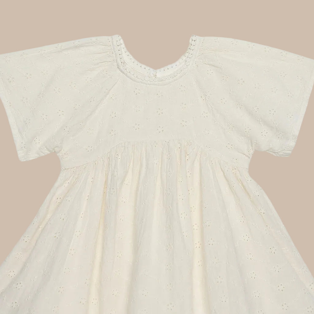 Beige baby dress with short sleeves on a white background