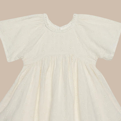 Beige baby dress with short sleeves on a white background