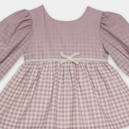 Pink checkered dress with lace detail on a white background