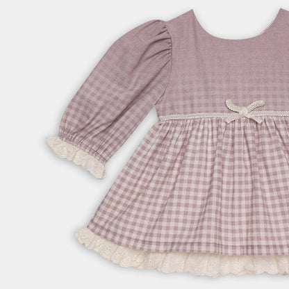 Pink checkered dress with lace trim on a white background