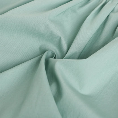 Close-up of light green fabric with folds
