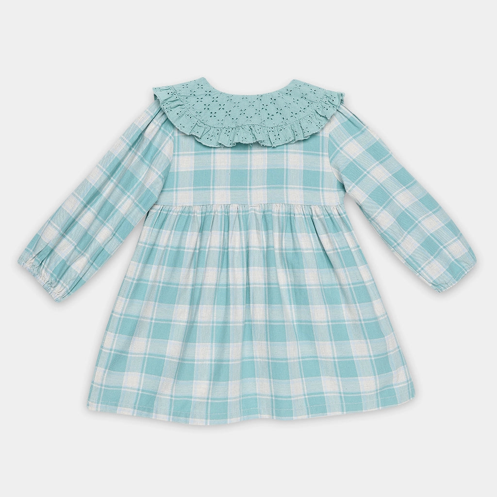 Children's dress with blue and white check pattern on a light gray background