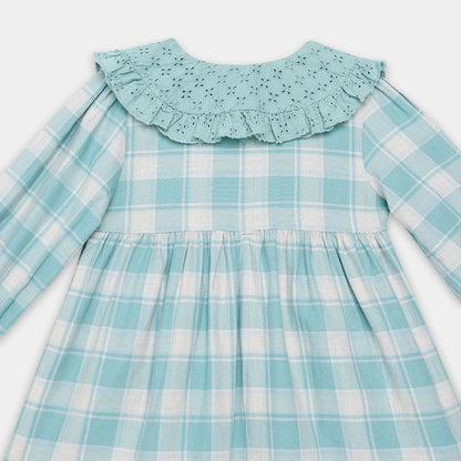 Children's dress with a blue and white checkered pattern on a light gray background