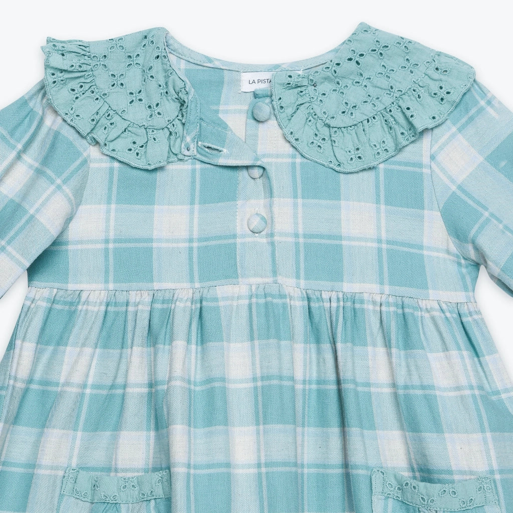 Teal plaid dress with ruffled collar on a white background