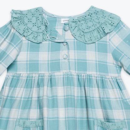 Teal plaid dress with ruffled collar on a white background