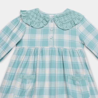 Teal and white checkered dress with a ruffled collar on a light gray background