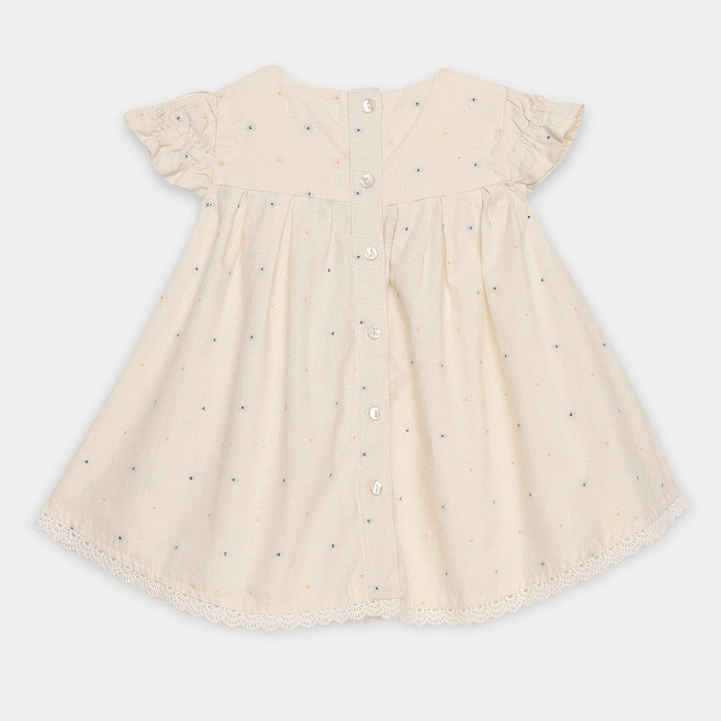 Beige dress with button details on a white background