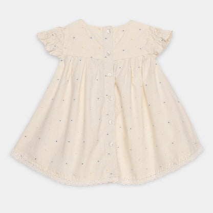 Beige dress with button details on a white background