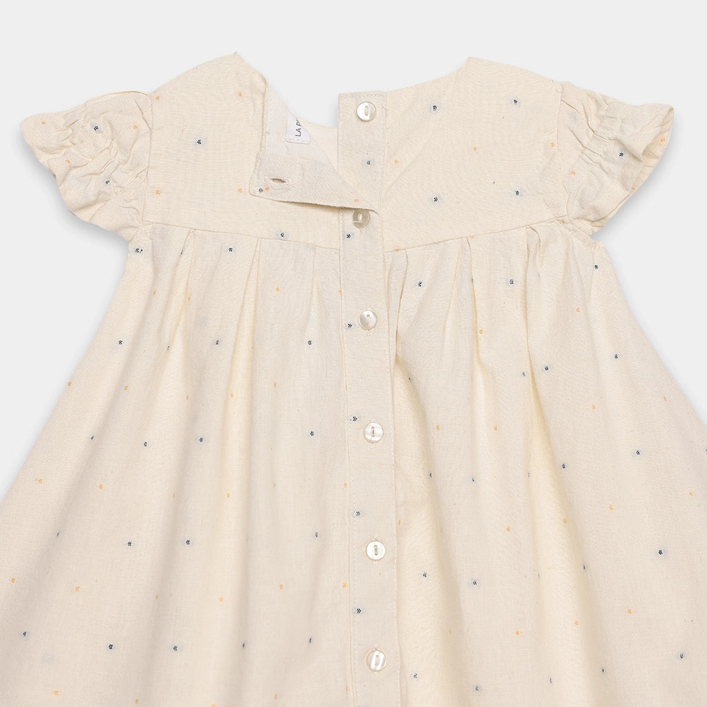 Beige dress with small patterns on a white background