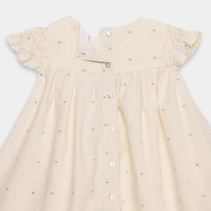 Beige dress with small patterns on a white background