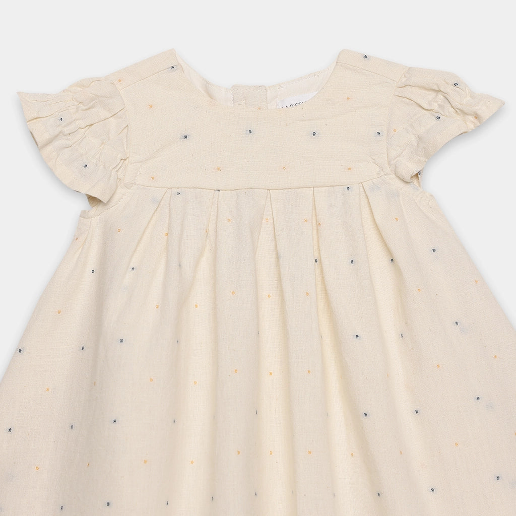Beige dress with small colorful patterns on a white background
