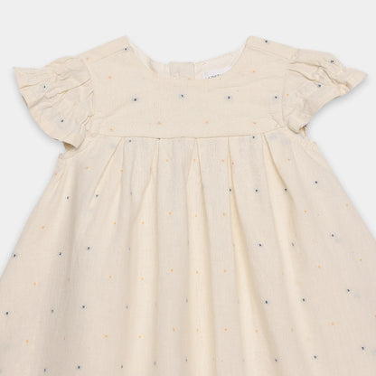 Beige dress with small colorful patterns on a white background