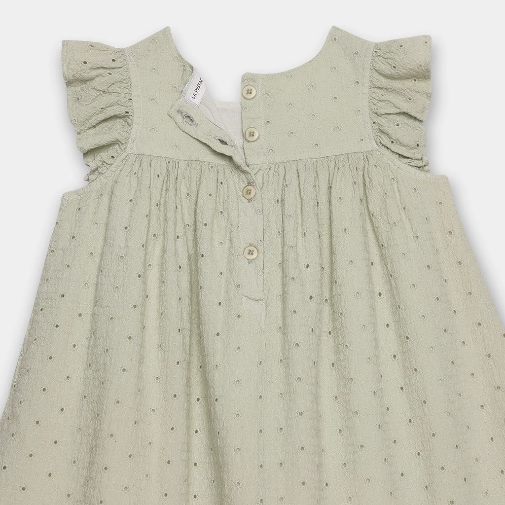 Green dress with ruffled shoulders on a white background