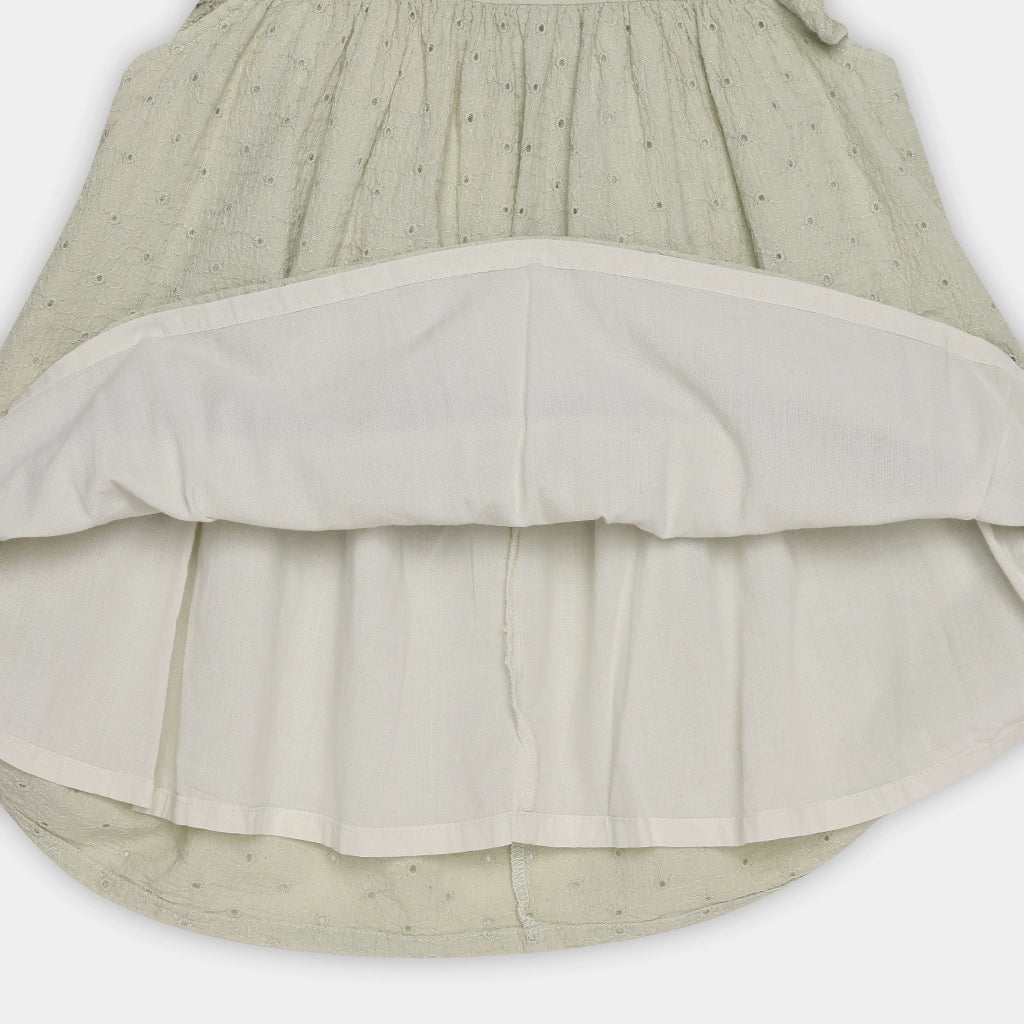 Two-layered skirt with a green top and beige bottom on a white background