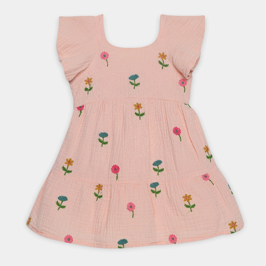 Pink dress with floral embroidery on a white background