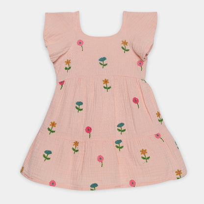 Pink dress with floral embroidery on a white background