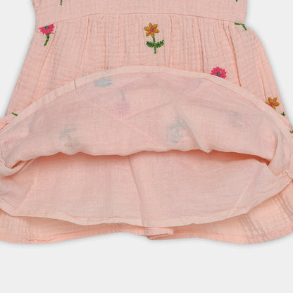 Pink dress with floral embroidery on a white background